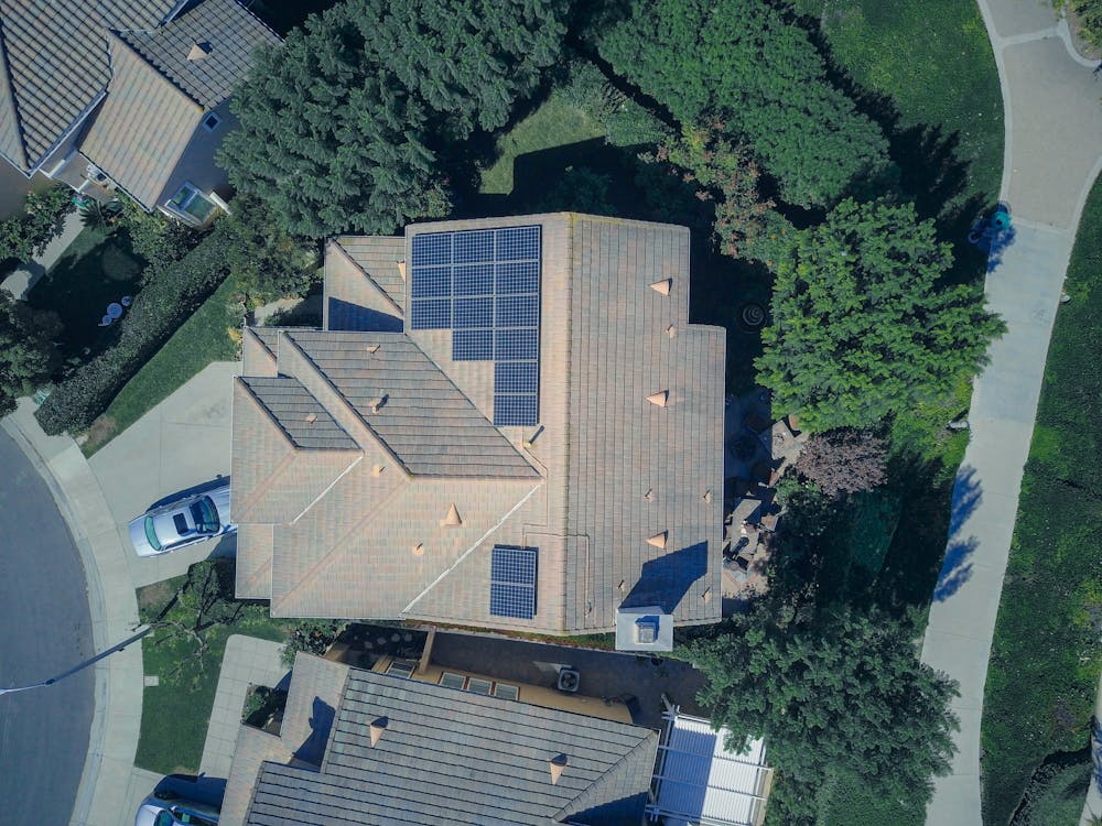 aerial view of large house with solar panels on roof