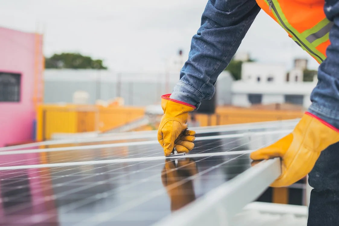 selective focus shot of worker installing solar panel