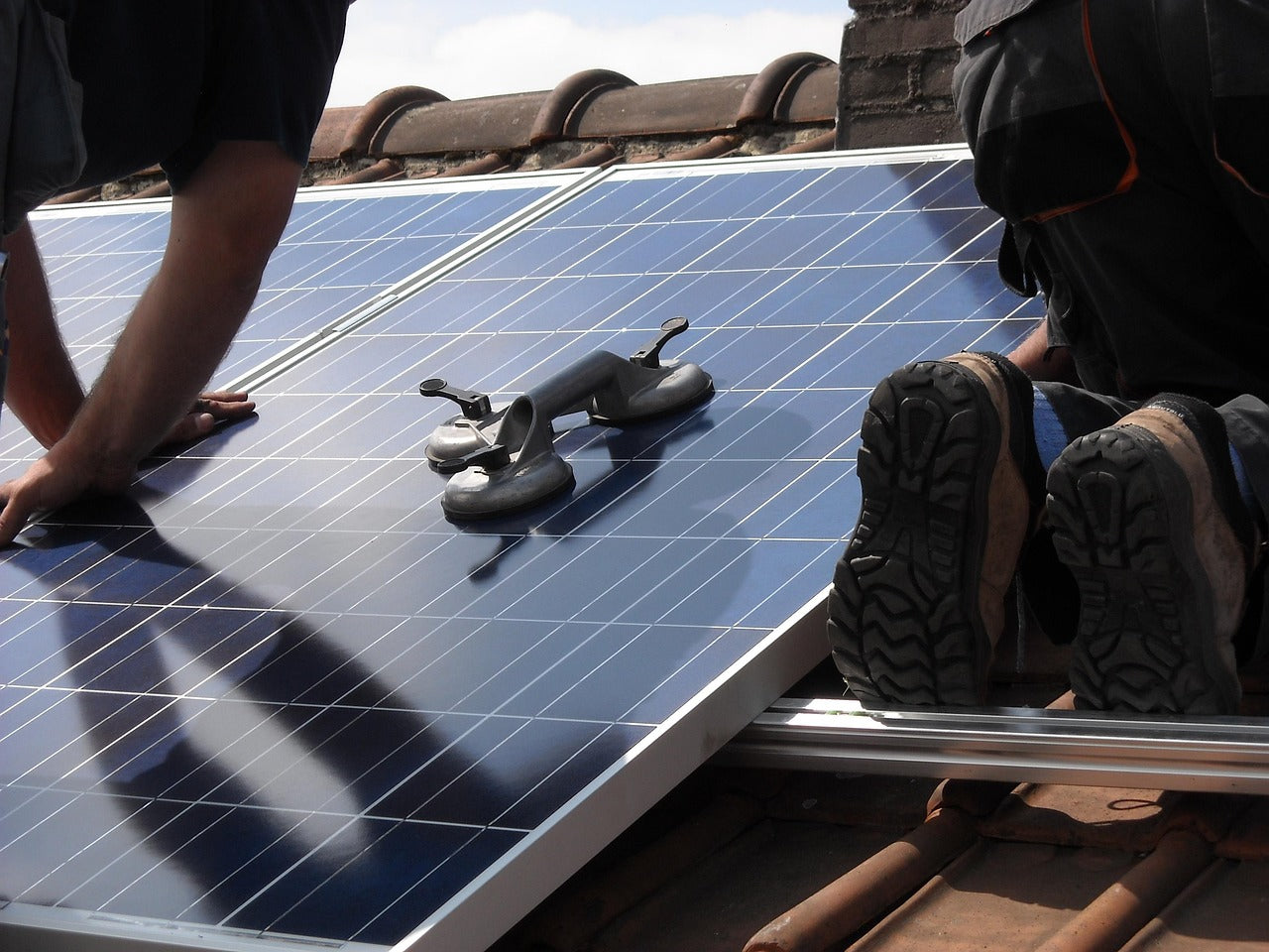 workers installing solar panel